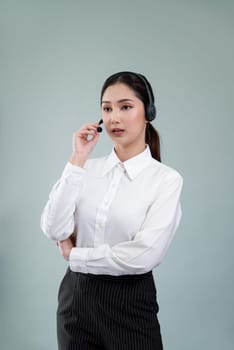 Attractive asian female call center operator with happy smile face advertises job opportunity on empty space, wearing a formal suit and headset on customizable isolated background. Enthusiastic