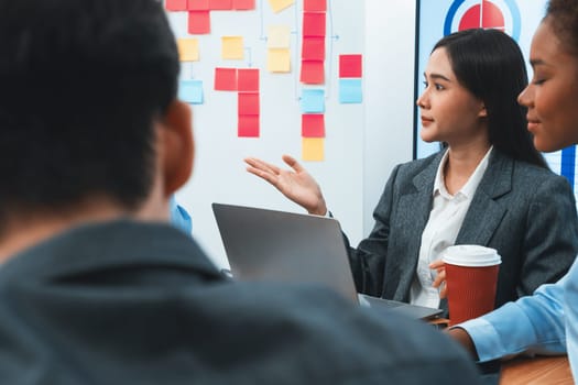 Young asian businesswoman presenting data analysis dashboard on TV screen in modern meeting. Business presentation with group of business people in conference room. Concord