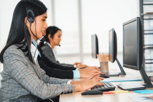 Business people wearing headset working in office to support remote customer or colleague. Call center, telemarketing, customer support agent provide service on telephone video conference call. Jivy