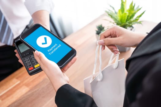 Seamless cashless payments with barcode scanning on smartphone application. Utilizing QR code technology, secure and fast transactions for modern shopping lifestyle with mobile banking app. Jubilant