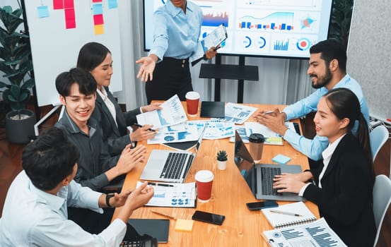 Young african businesswoman presenting data analysis dashboard on TV screen in modern meeting. Business presentation with group of business people in conference room. Concord