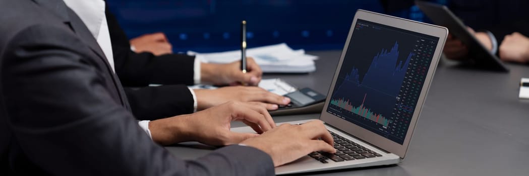 Group of stock trading investor or business people discussing and analyzing financial data graph on stock market together in meeting room. Stock trading or exchange investment planning. Trailblazing