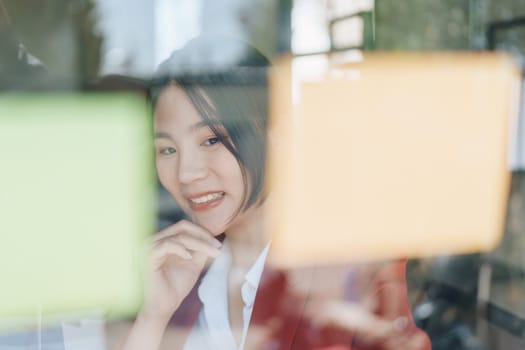 Beautiful young teen asian businesswoman using note pad thinking with planning working on financial document, tax, exchange, accounting and Financial advisor.