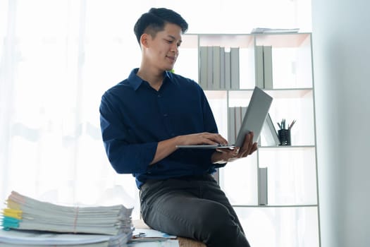 Businessman using computer laptop with planning working on financial document, tax, exchange, accounting and Financial advisor