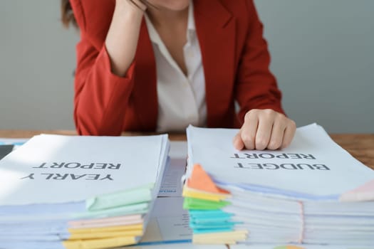 Portrait of business owner, woman using computer and financial statements Anxious expression on expanding the market to increase the ability to invest in business.