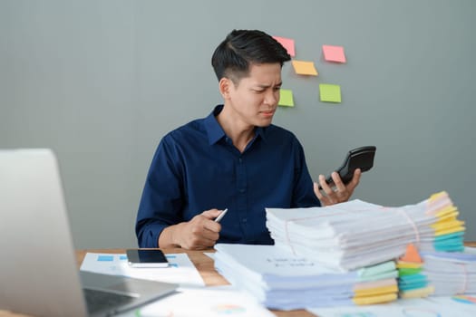 Portrait of business owner, man using computer and financial statements Anxious expression on expanding the market to increase the ability to invest in business