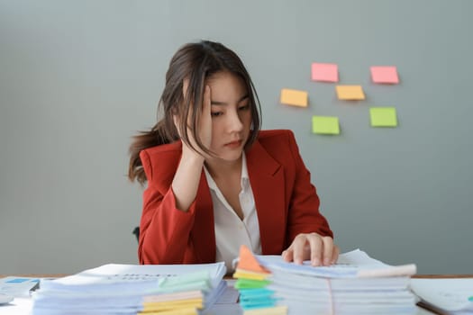 Portrait of business owner, woman using computer and financial statements Anxious expression on expanding the market to increase the ability to invest in business.