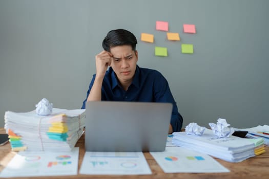 Portrait of business owner, man using computer and financial statements Anxious expression on expanding the market to increase the ability to invest in business