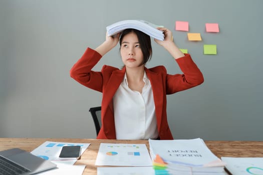 Portrait of business owner, woman using computer and financial statements Anxious expression on expanding the market to increase the ability to invest in business.