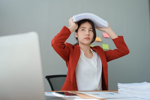 Portrait of business owner, woman using computer and financial statements Anxious expression on expanding the market to increase the ability to invest in business.