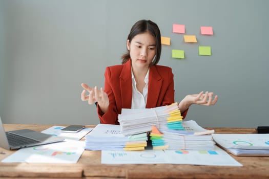 Portrait of business owner, woman using computer and financial statements Anxious expression on expanding the market to increase the ability to invest in business.