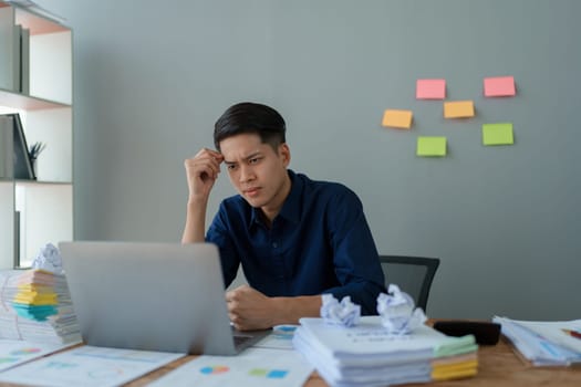 Portrait of business owner, man using computer and financial statements Anxious expression on expanding the market to increase the ability to invest in business