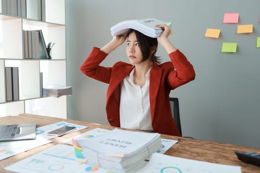 Portrait of business owner, woman using computer and financial statements Anxious expression on expanding the market to increase the ability to invest in business.