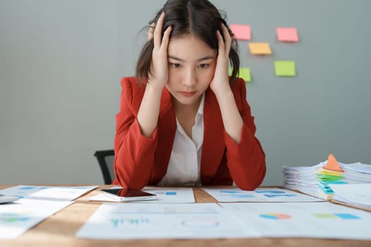 Portrait of business owner, woman using computer and financial statements Anxious expression on expanding the market to increase the ability to invest in business.