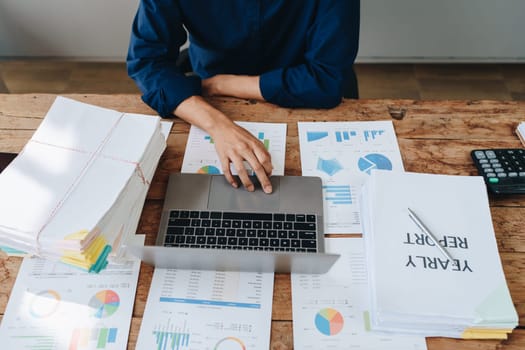 Businessman using computer laptop with planning working on financial document, tax, exchange, accounting and Financial advisor