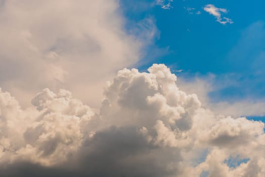 Sky with huge white clouds in spring on a sunny day. Huge white clouds on the sunny day background