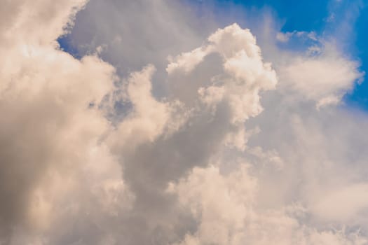 Sky with huge white clouds in spring on a sunny day. Huge white clouds on the sunny day background