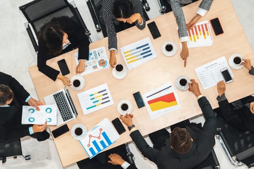 Business people group meeting shot from top view in office . Profession businesswomen, businessmen and office workers working in team conference with project planning document on meeting table . Jivy