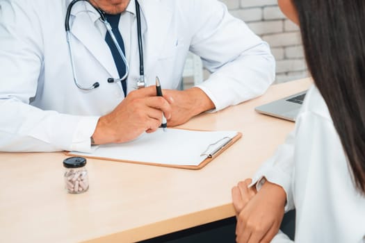 Doctor in professional uniform examining patient at hospital or medical clinic. Health care , medical and doctor staff service concept. Jivy