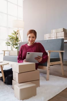 Businesswoman with Laptop and Parcel Box. A Symbol of SME Success in E-Commerce