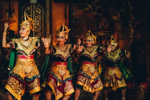 UBUD, BALI, INDONESIA - FEBRUARY 10, 2023: Traditional dance Legong and Barong in Ubud Palace, Balinese dance show with colorful dressed artists. Traditional balinese religious ritual performance