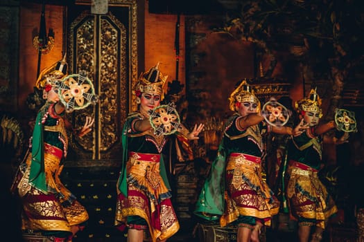 UBUD, BALI, INDONESIA - FEBRUARY 10, 2023: Traditional dance Legong and Barong in Ubud Palace is performed by local professional actors with colorful clothes, expressive gestures, facial expressions