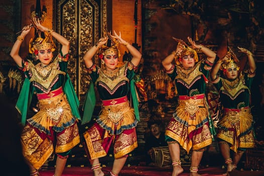 UBUD, BALI, INDONESIA - FEBRUARY 10, 2023: Traditional dance Legong and Barong in Ubud Palace, Balinese dance show with colorful dressed artists. Traditional balinese religious ritual performance