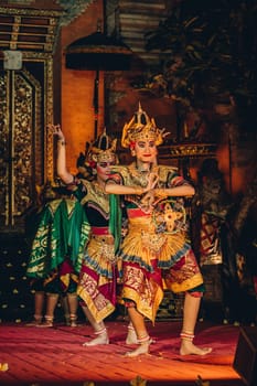 UBUD, BALI, INDONESIA - FEBRUARY 10, 2023: Traditional dance Legong and Barong in Ubud Palace is performed by local professional actors with colorful clothes, expressive gestures, facial expressions