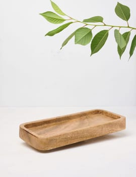 Rectangular brown wooden stand on a white background, a place to display cosmetics and products