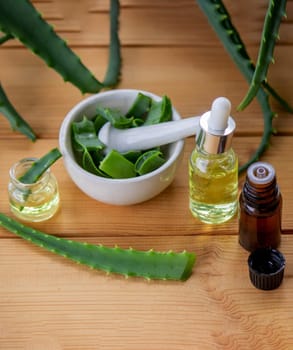 aloe vera essential oil on a wooden background, juice. Selective focus