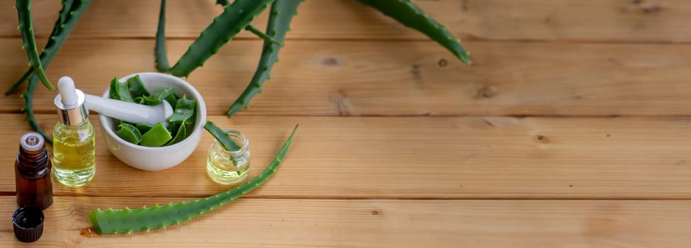 aloe vera essential oil on a wooden background, juice. Selective focus