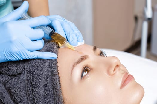 procedure Plasmolifting injection. plasma injection into the skin of the forehead of the patient