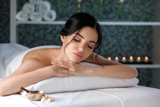 Relaxed beautiful young woman in spa salon. Beauty treatment
