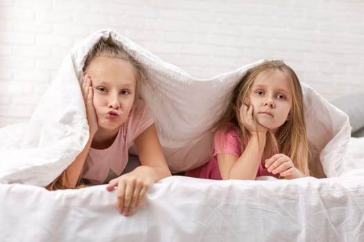 happy smiling morning kids in bed. children dabble in bed