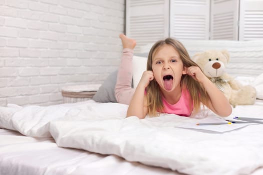 cute little child girl fooling around in bed