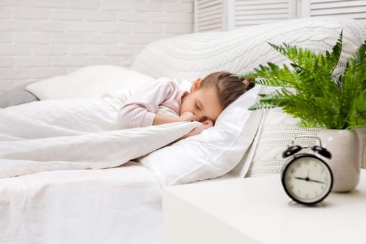 Cute little child girl sleeping in her bed
