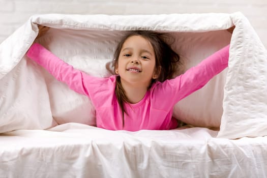 happy morning baby in bed. child dabbles in bed