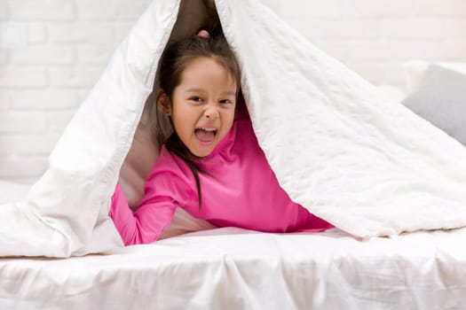 happy morning baby in bed. child dabbles in bed