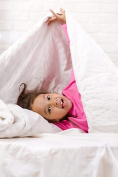 happy morning baby in bed. child dabbles in bed