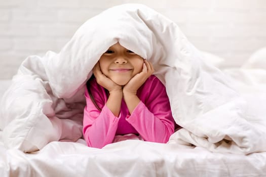 happy morning baby in bed. child dabbles in bed