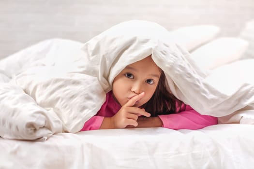 happy morning baby in bed. child dabbles in bed