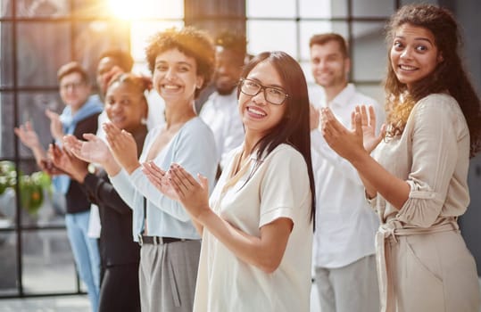 arge international group of happy people applauding together
