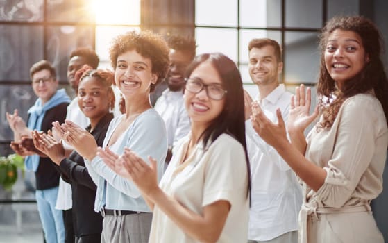 arge international group of happy people applauding together