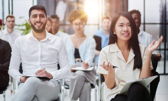 Diverse people participating in a group business training session