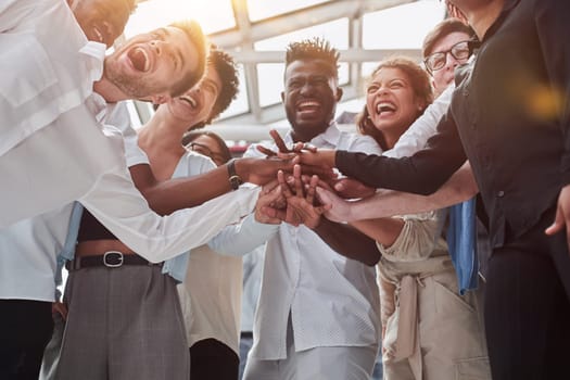 A group of international business people are standing in a modern office