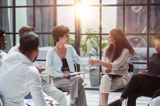 Manager greeting new employee and smiling in office