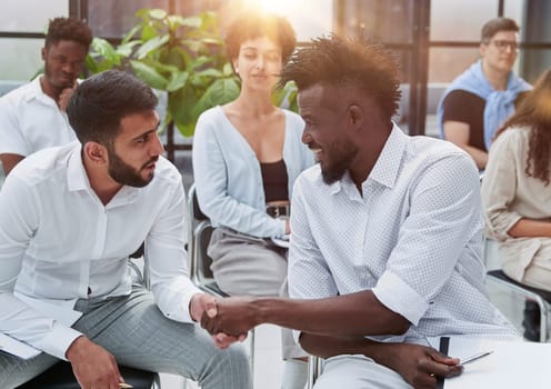 Business people sharing expressions after lecture in conference room