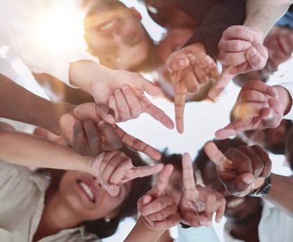 group of diverse young people standing in a circle and looking down