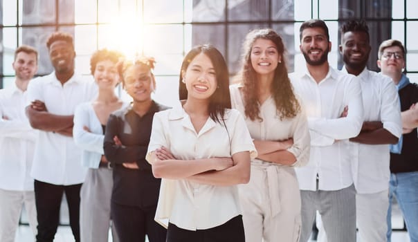 Happy diverse professional business team stand in office looking at camera