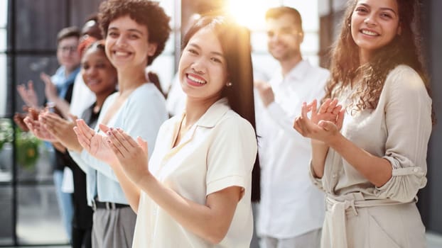 arge international group of happy people applauding together